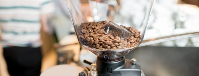 Illustration of coffee beans in a grinder