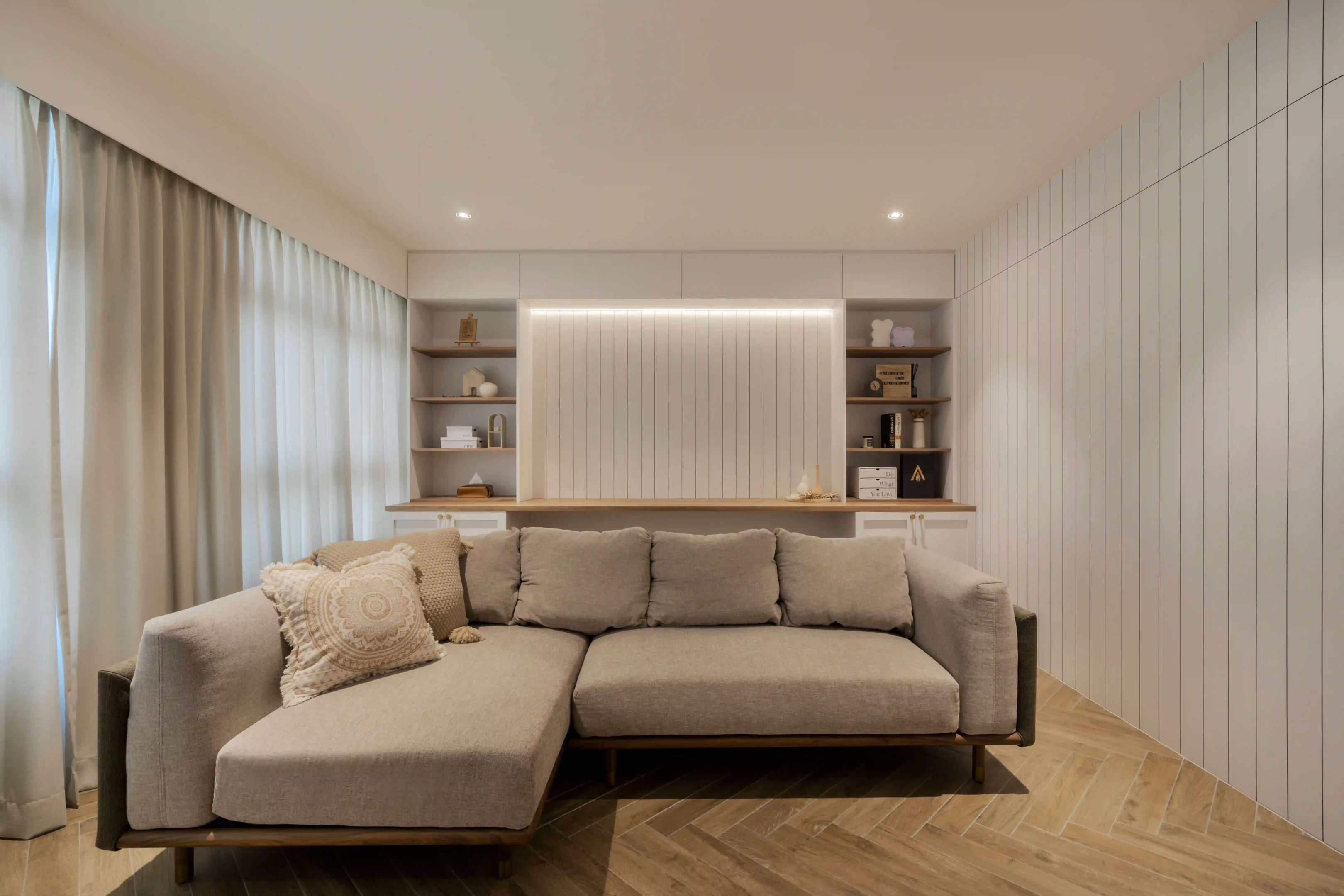 Minimalist living room with LED cove smart lights washing vertical panelling, paired with a textured sectional sofa.