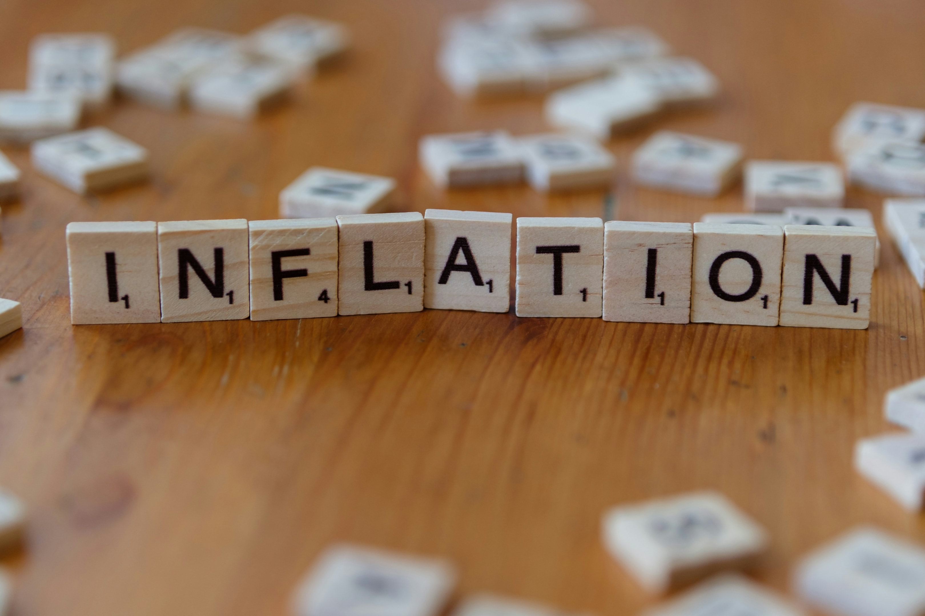 Scrabble tiles spelling out inflation, which has a big effect on investors interested in farmland.