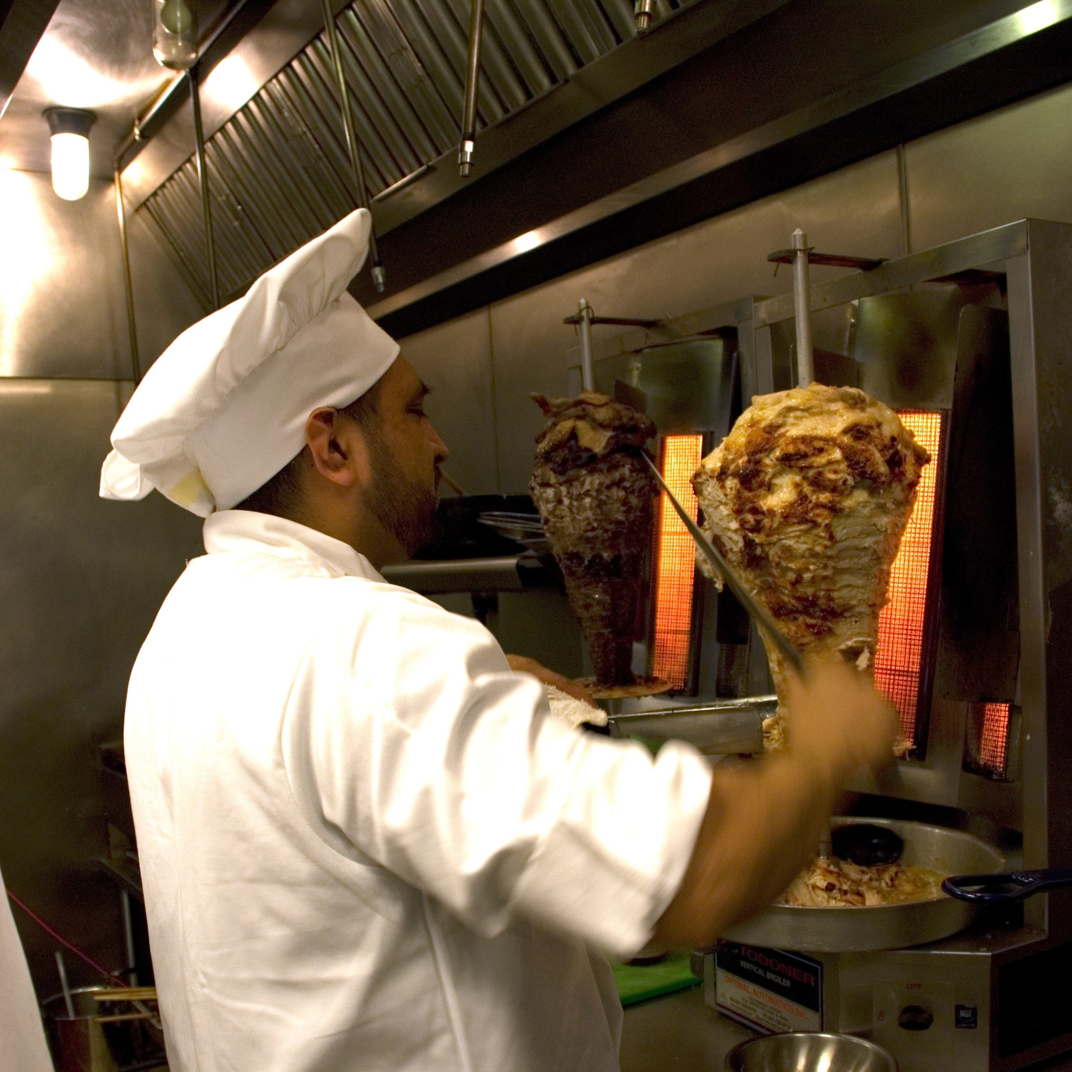 Chicken shawarma being carved at NAYA Mezze & Grill in 2008 when we were a fine dining concept.  Find a Naya near you for delicious perfectly tender chicken or beef shawarma 