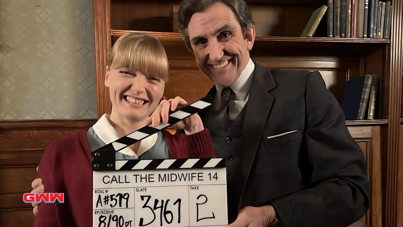 Stephen McGann as Dr Turner and Natalie Quarry as Nurse Clifford in Call the Midwife season 14 holding up a clapperboard.