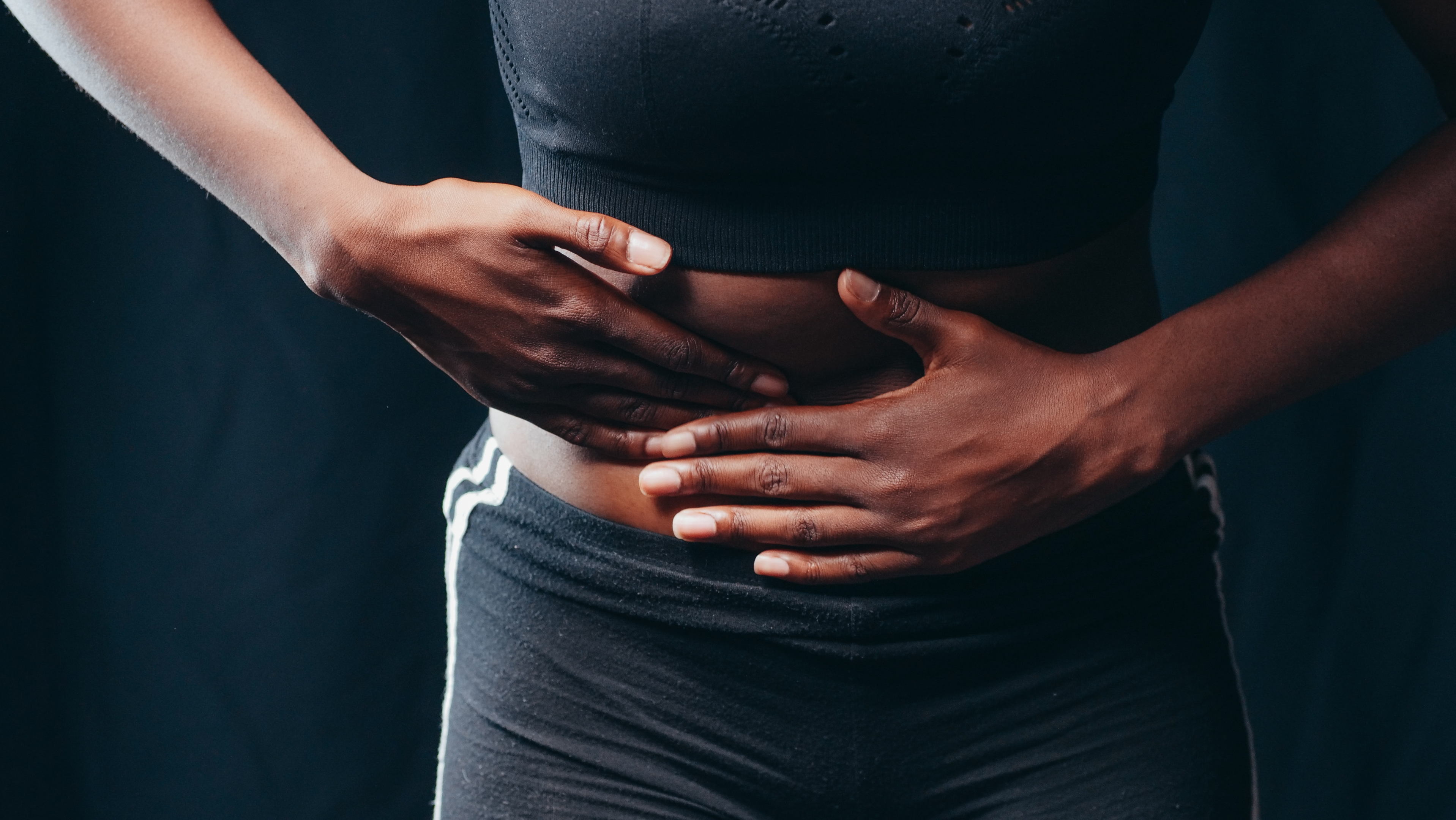 https://www.pexels.com/photo/person-wearing-black-active-wear-holding-her-tummy-7298905/