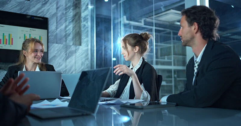 Colleagues reviewing strategy together, considering the role artificial intelligence plays in navigating change and opportunity.