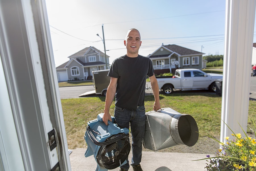 a technician ready to install air ducts at a customer home in tempe