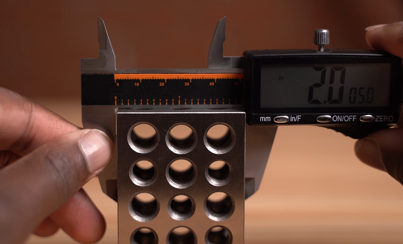 using Hardell digital caliper to measure the outside of a 2 inch block