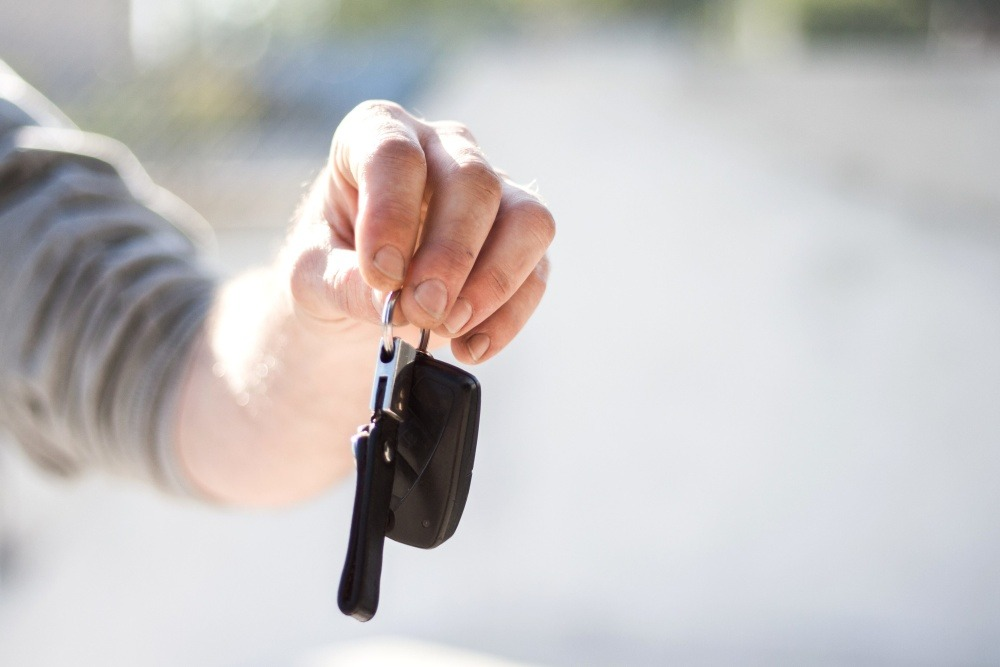 Person handing out a motorcycle key
