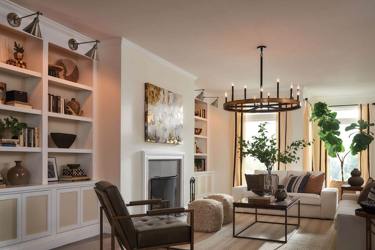 Warm living room with the Hinkley Wells Medium Single Tier chandelier hanging above a seating area with neutral decor and built-in shelving.