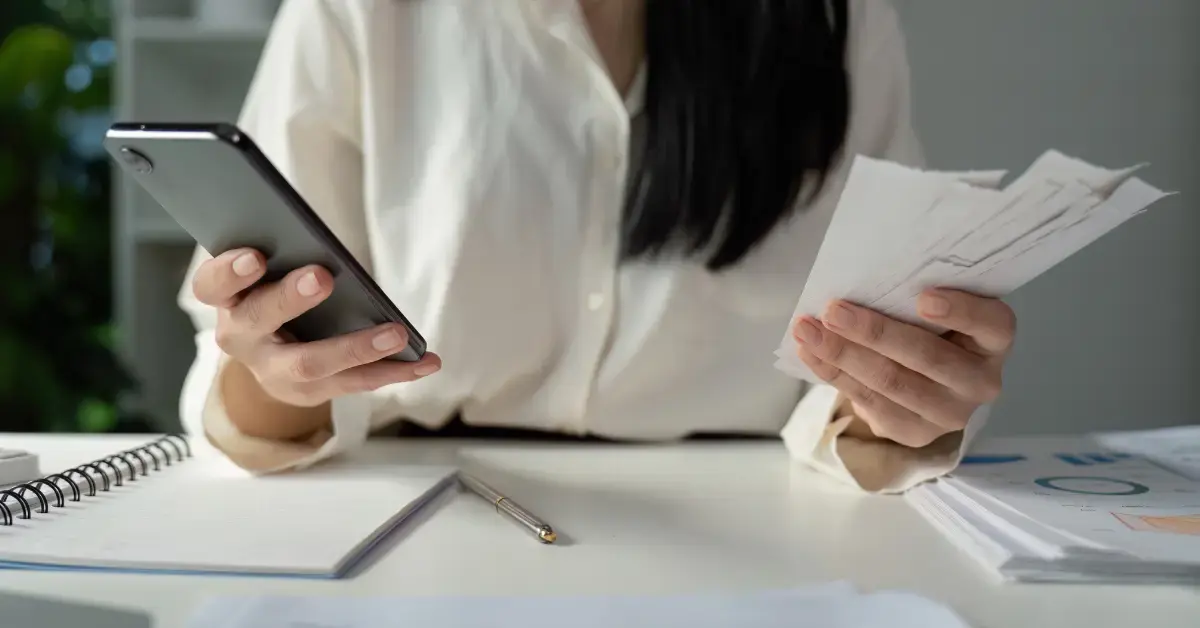 Woman reviewing creator income paperwork and hobby loss rules for tax deductions.