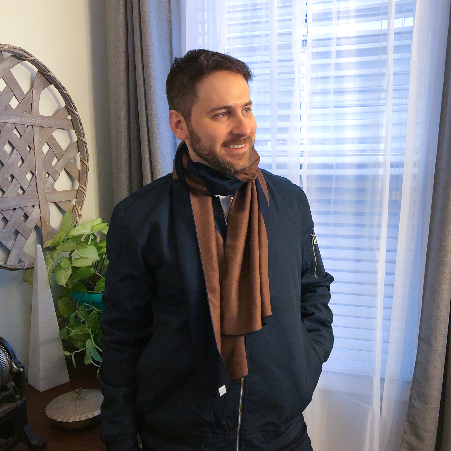 Tiffany Waldorf's husband sporting a scarf and jacket combo from Menlo's clothing subscription box for men.