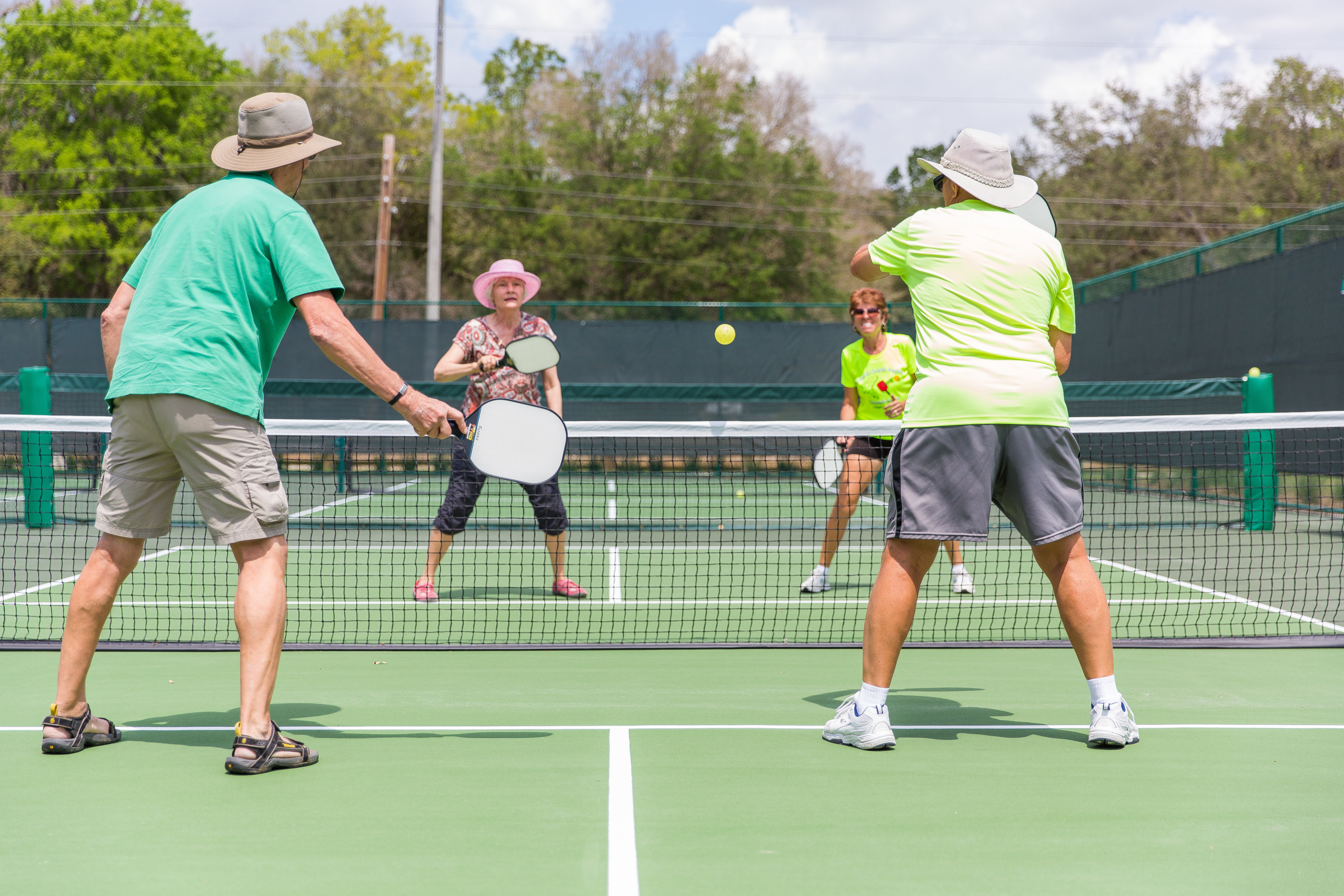 Pickleball court with net and two players playing