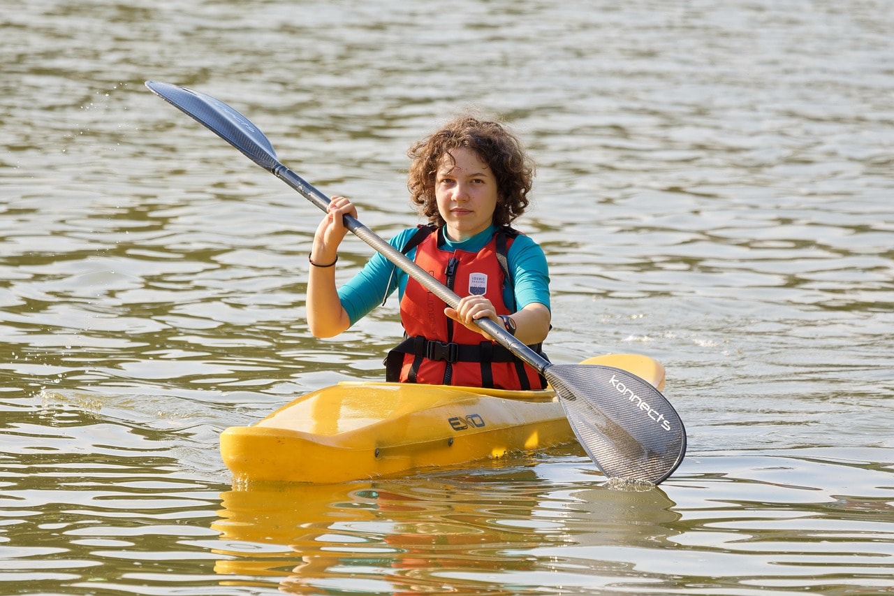 A child wearing life jacket during kayaking.