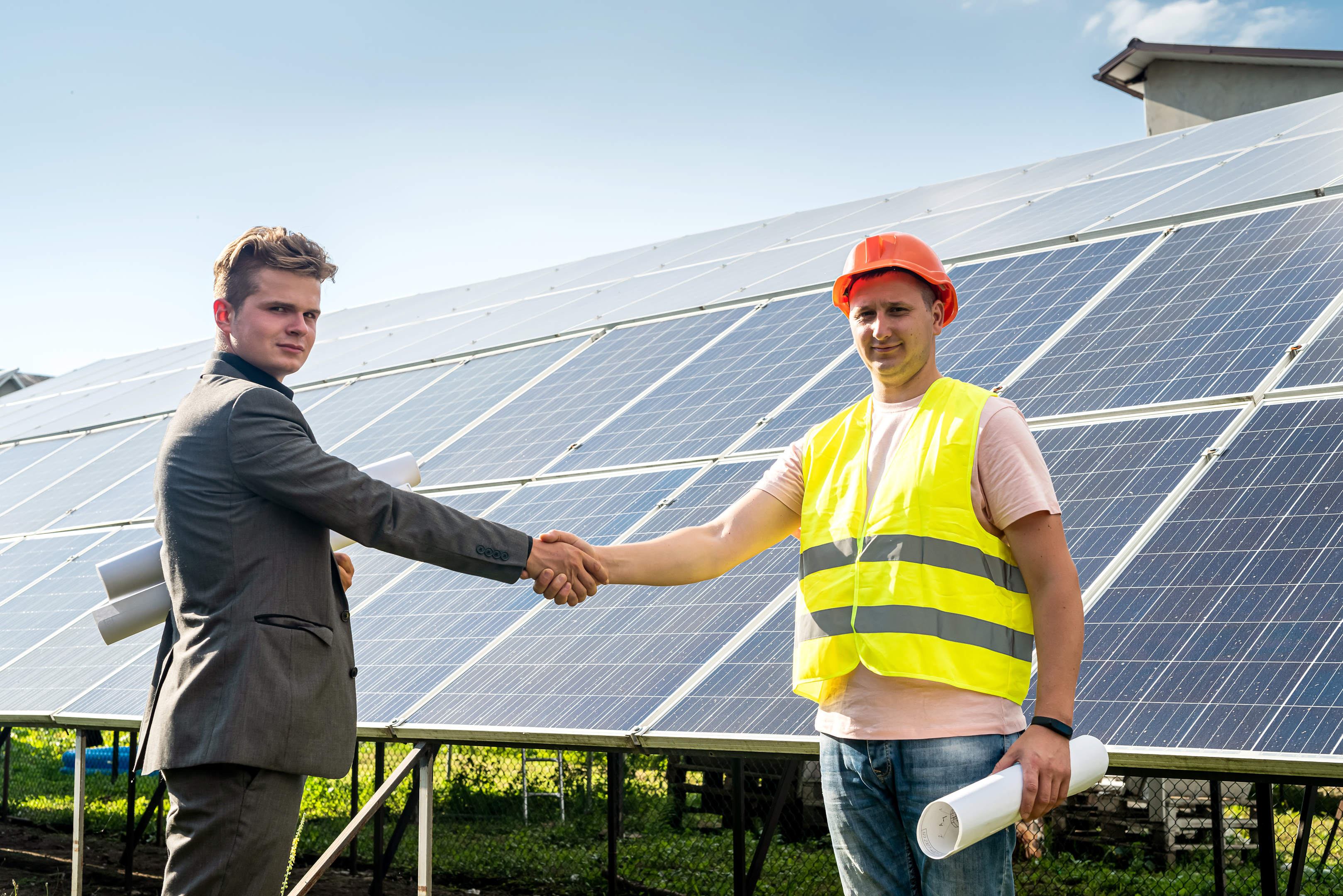 Project manager and worker finished installation of solar panels