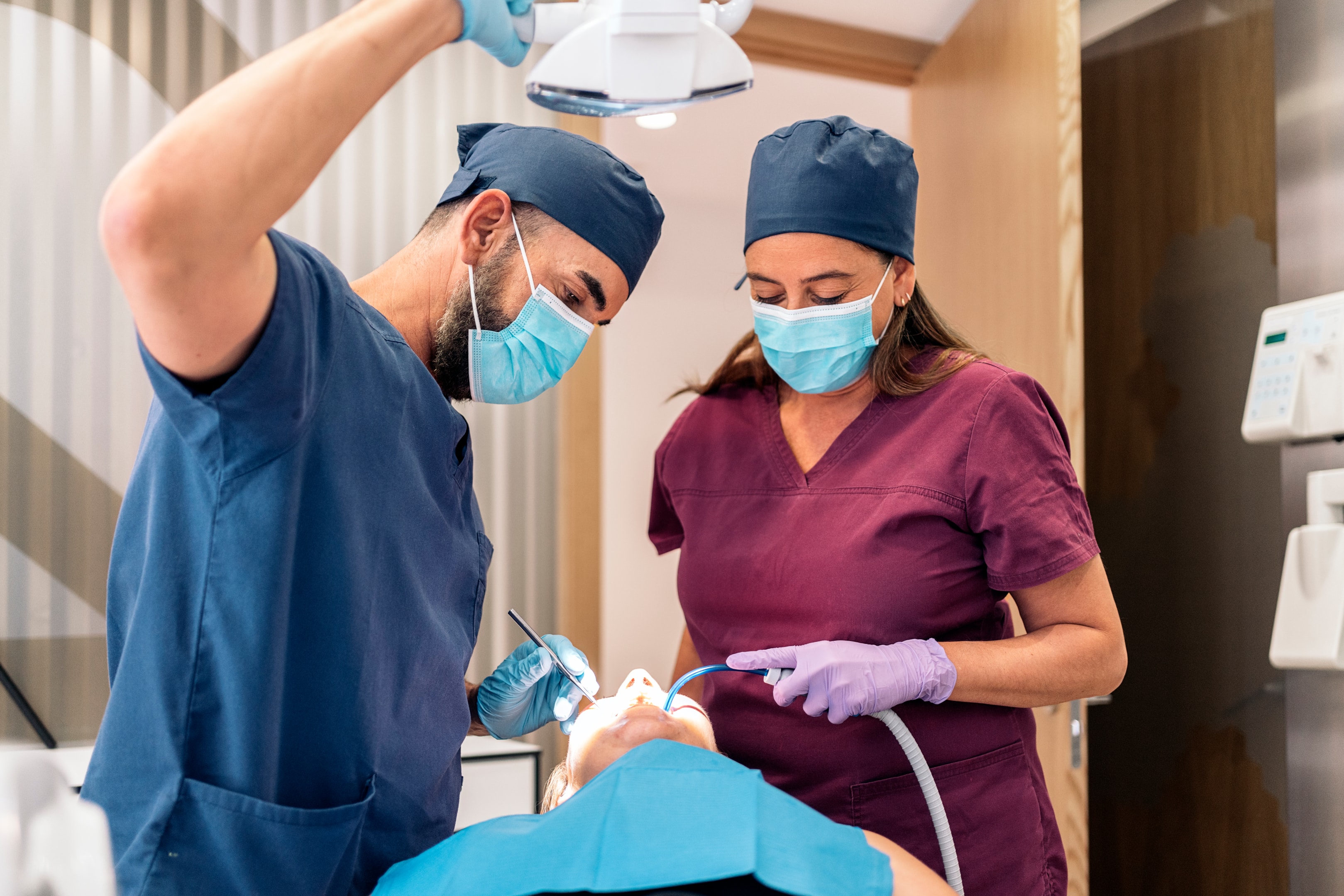 An image of an oral surgeon with an extracted teeth.