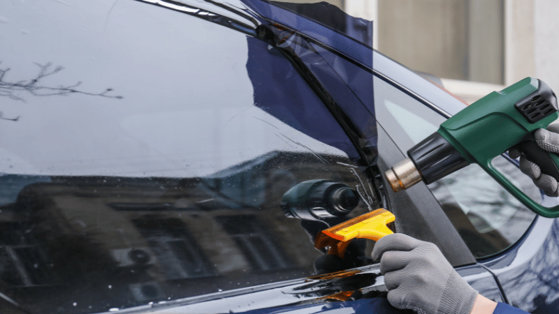 A man is applying the Nano-ceramic tint.