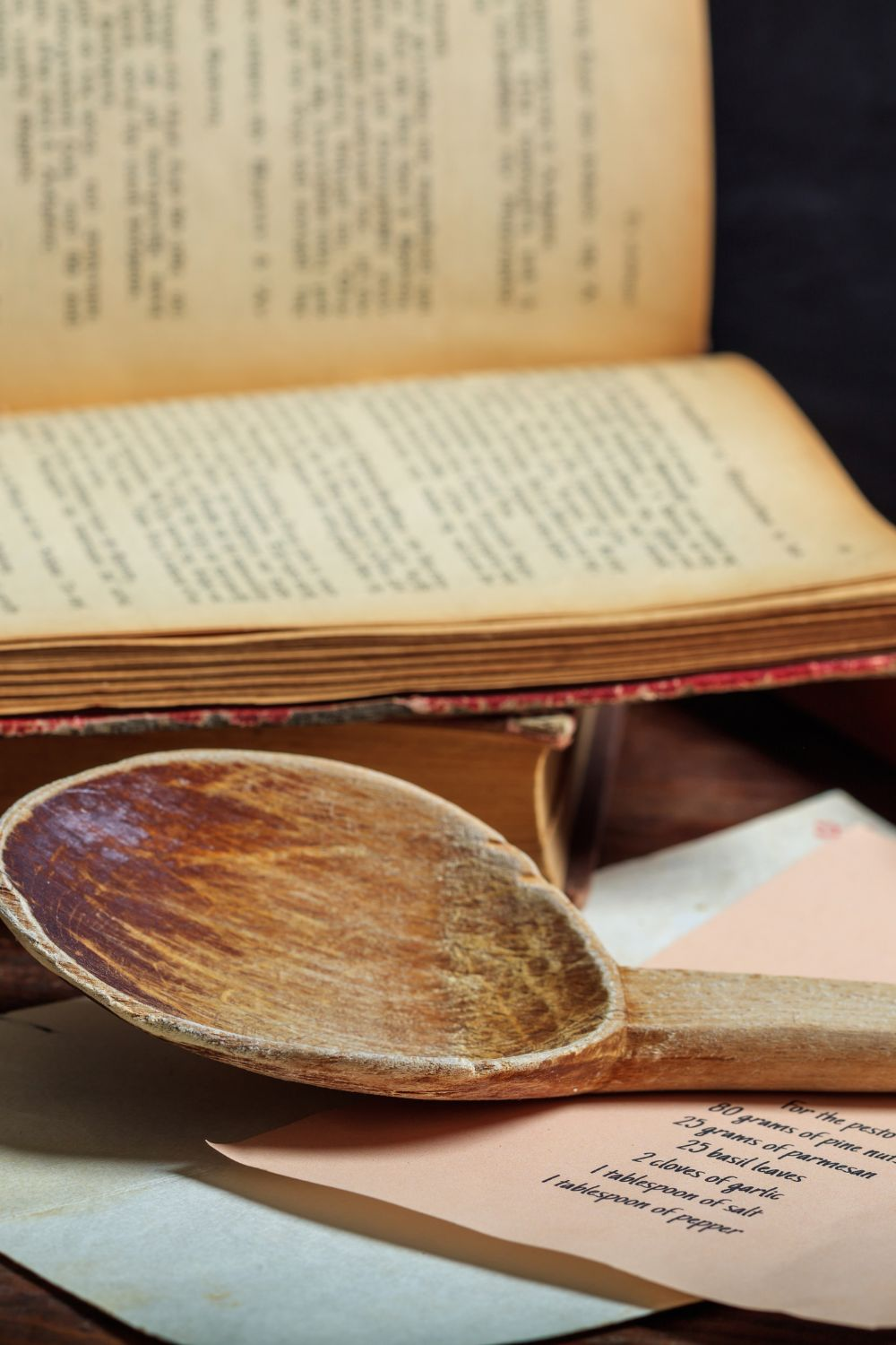 old cookbook and a wooden spoon