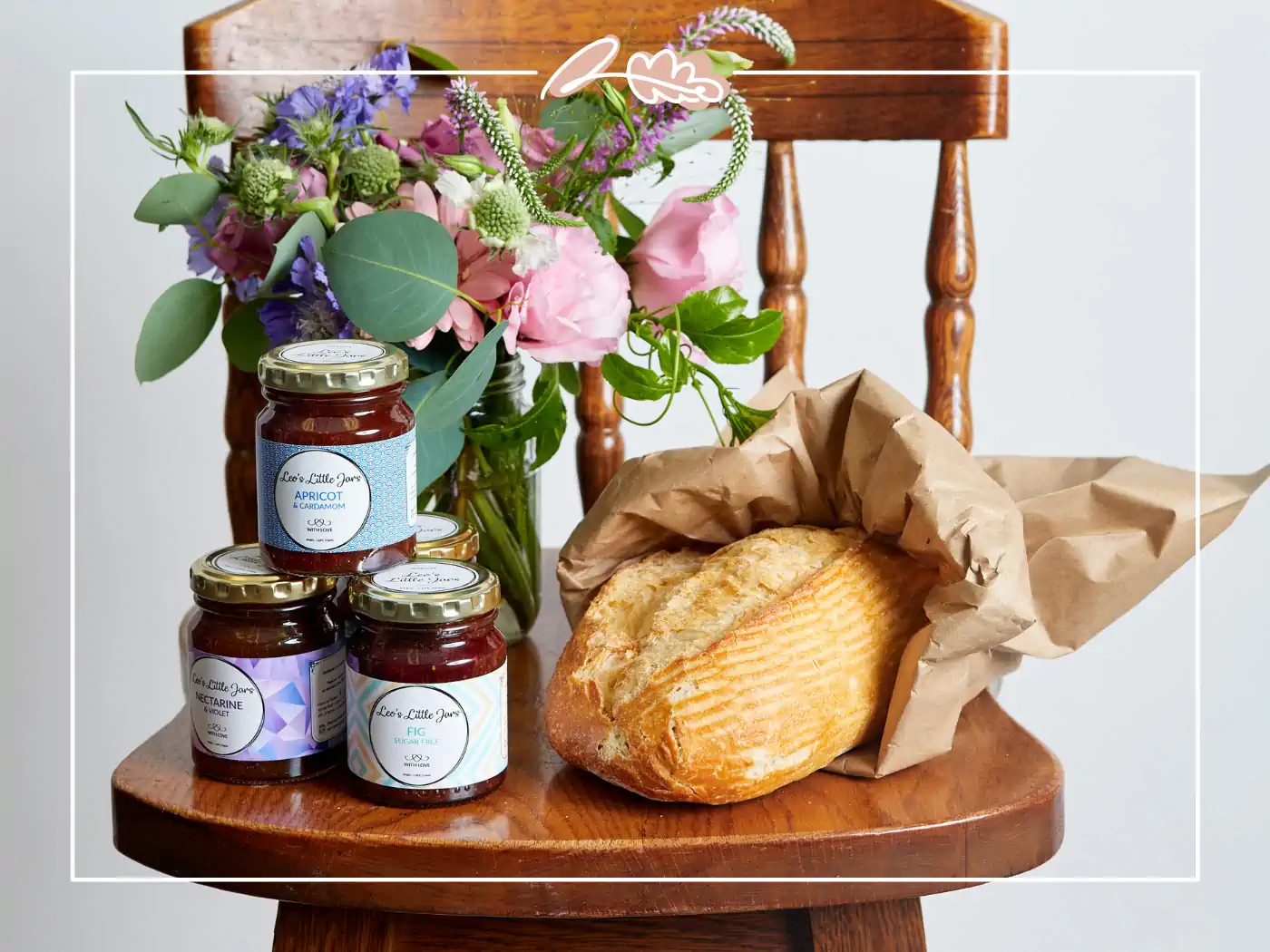 Flower arrangement, jars of jam, and a loaf of bread on a wooden chair, Fabulous Flowers and Gifts