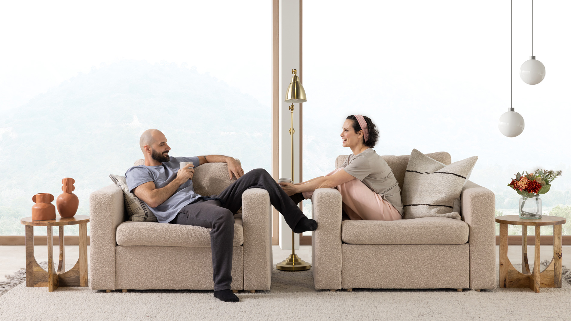 A couple sitting on two Beige living room chairs