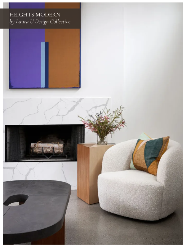 the living room at Heights Modern with a stone fireplace that acts as a focal point for the living space