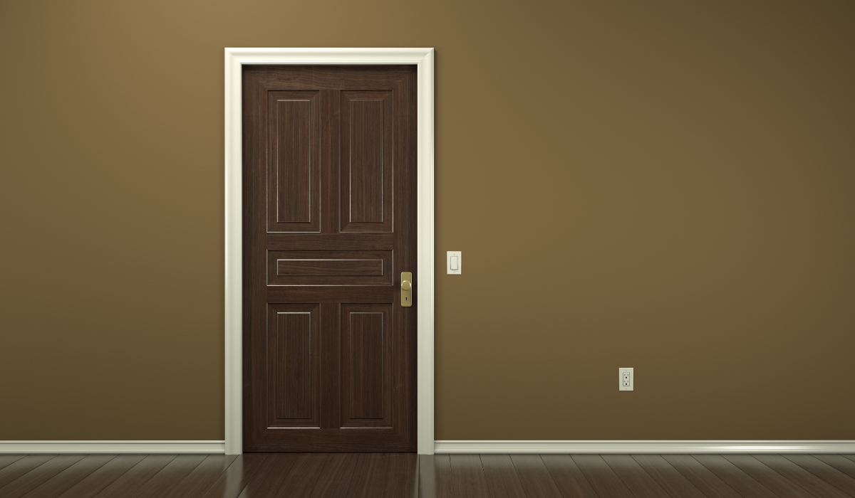 Traditional internal doors - darl wood 5-panelled door in empty parquet floored room