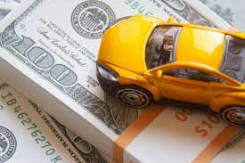 An image showing a stack of cash next to a car, representing the question of how much cash for car is needed to tie up funds.