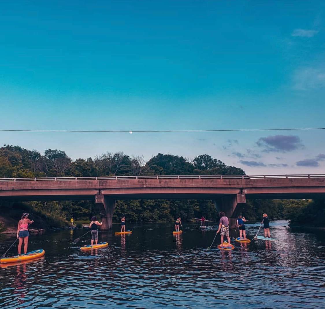 group on inflatable paddle boards