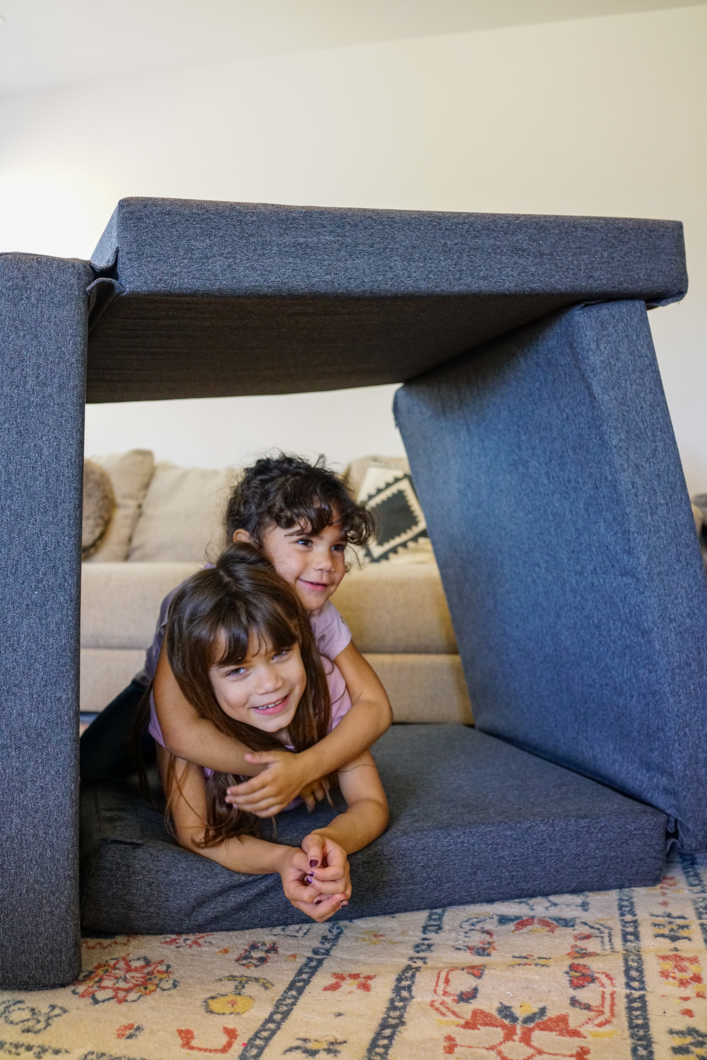 Siblings playing on a Figgy Play Couch