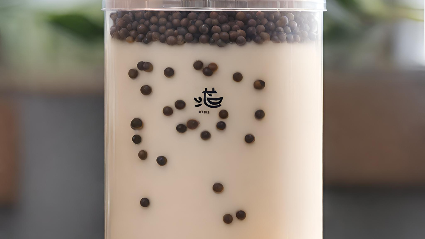 Airtight container with milk tea and boba pearls
