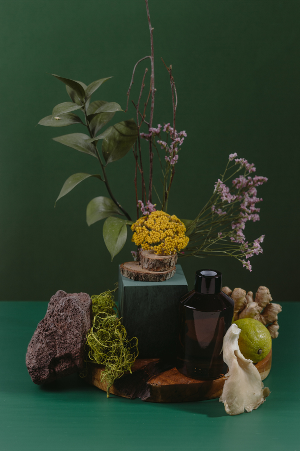 a green room with plants and bottles and a lively accent of apple green in the foreground