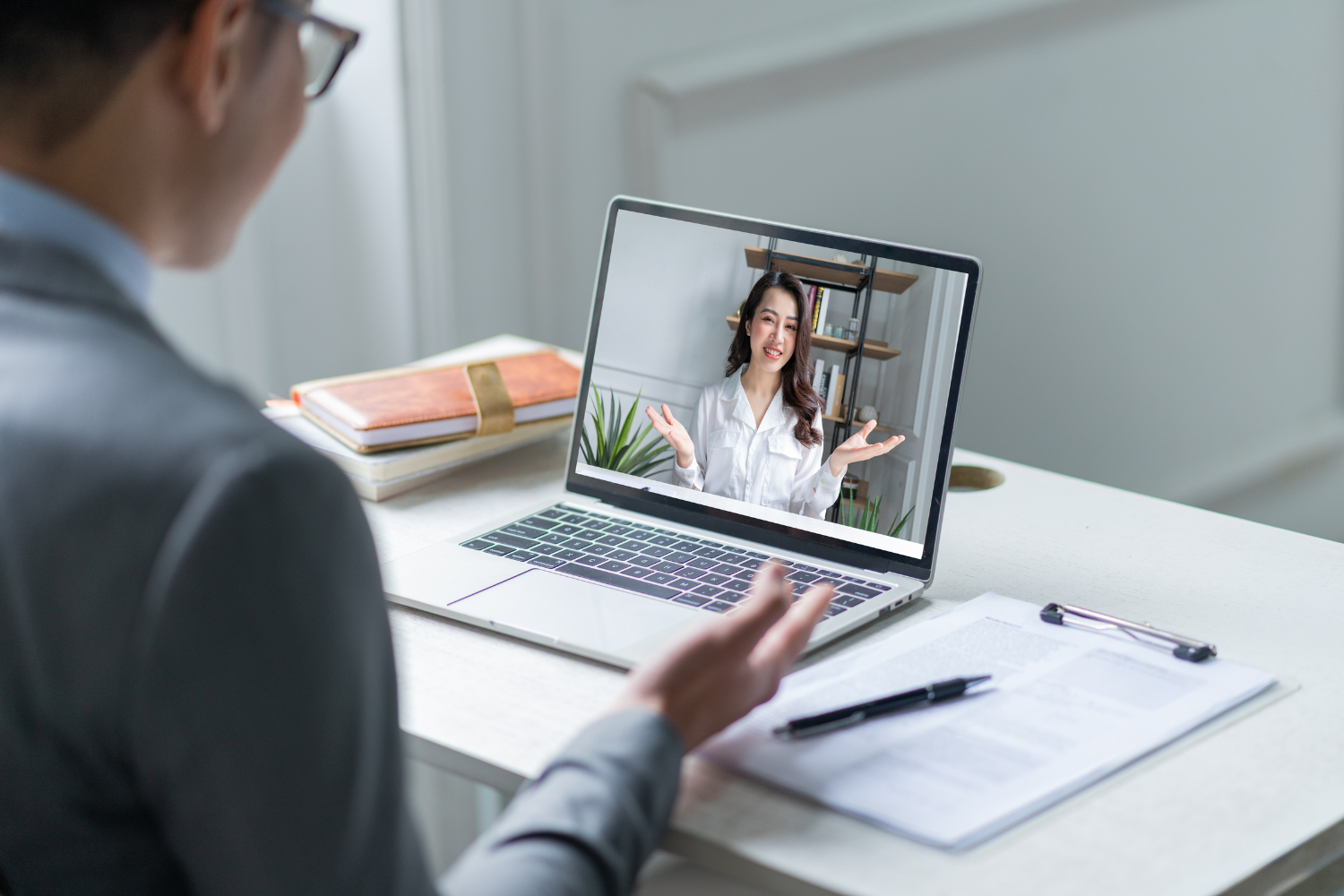A remote Filipino worker smiling on a video call with a U.S. manager.