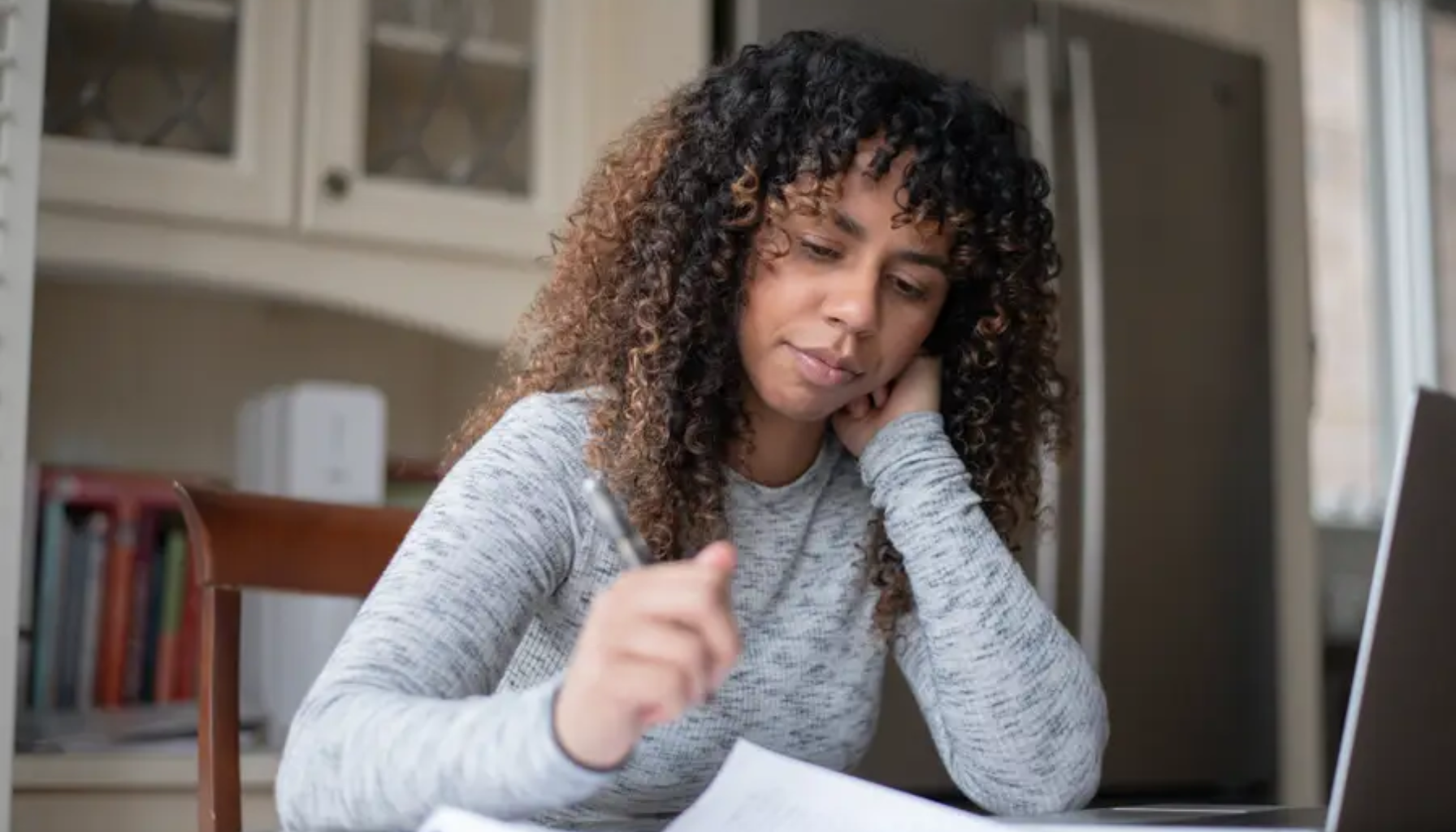 Kvinne jobber hjemmefra ved kjøkkenbordet, tar notater og ser konsentrert ut mens hun leser papirer ved siden av en bærbar datamaskin. barn og unge behov for kjeveortopedisk behandling typer tannregulering trenger tannregulering kjeveortopedisk behandling hos tannlegen tradisjonell tannregulering fyller 20 år ta kontakt 20 år typen regulering manglende tenner trenger ulike betale prisen kjeveortoped pris munnen barnet priser videre litt offentlige nødvendig tannreguleringen