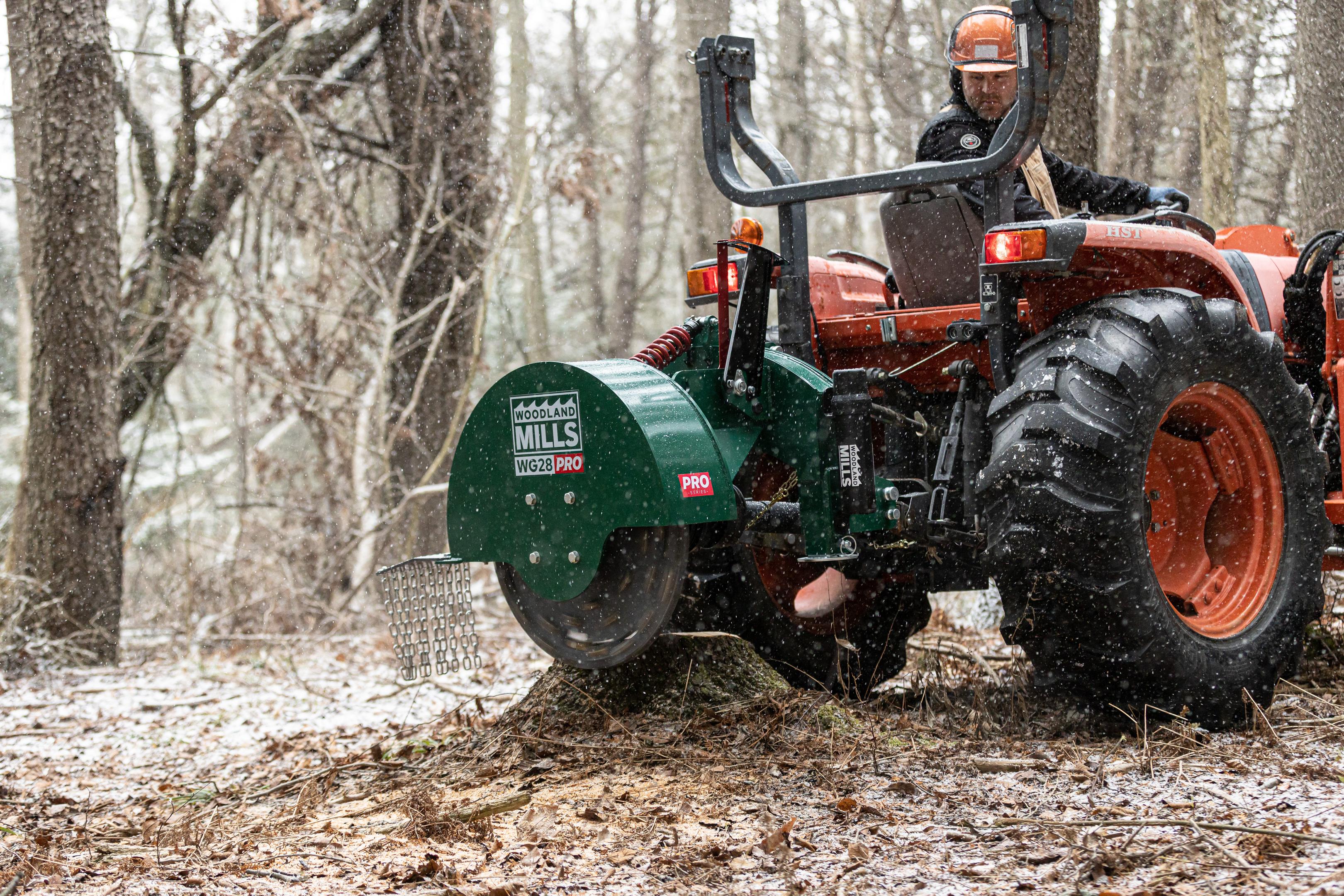 A Woodland Mills WG28 PRO stump grinder attached to a tractor.