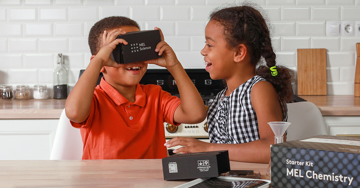 A child wearing a VR headset while doing a science lesson