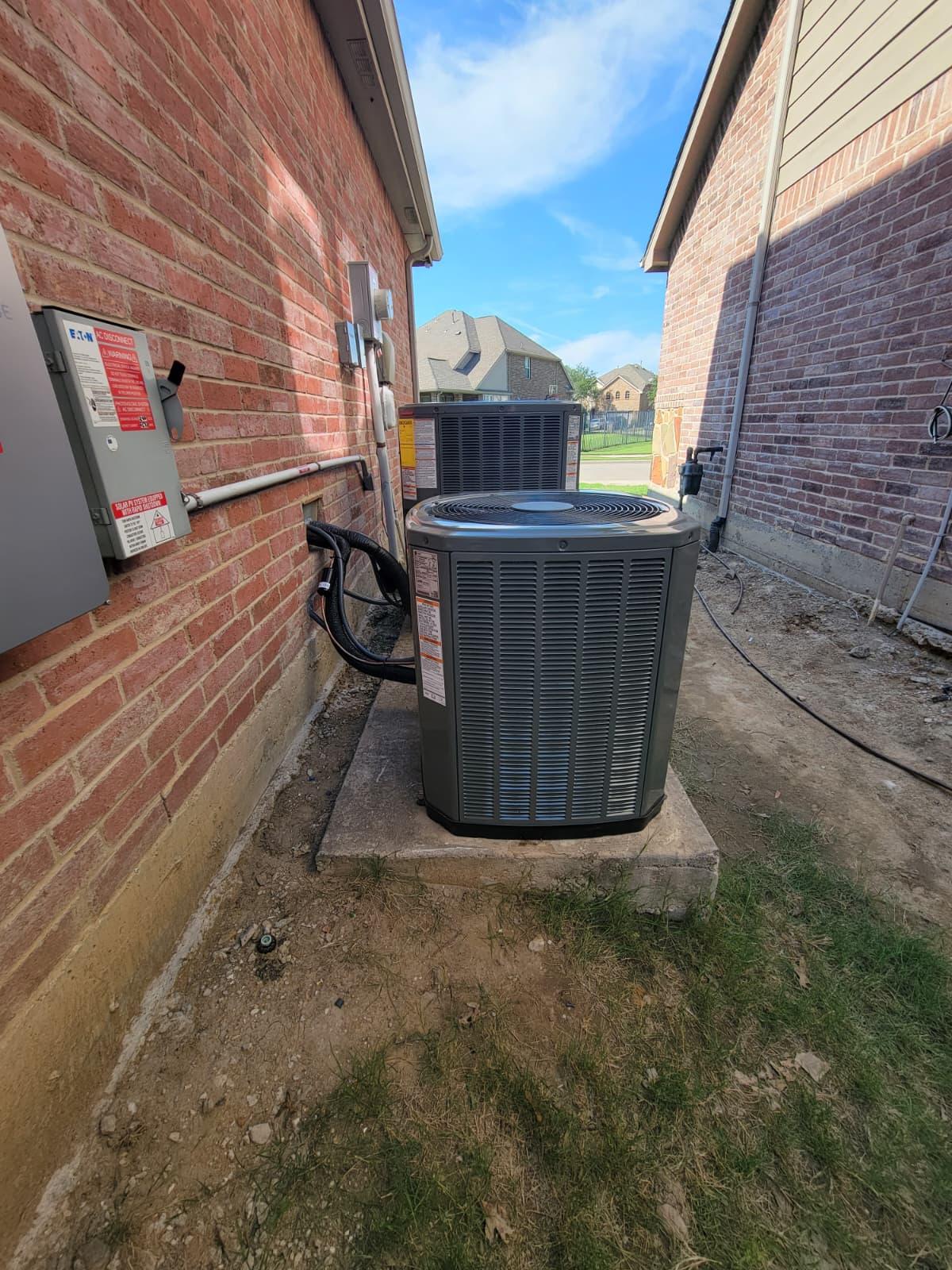 The image shows a newly installed Trane air conditioner in a side yard, featuring an outdoor condenser unit designed for efficient cooling. This system is part of a central HVAC setup, ensuring year-round comfort and energy savings for the home.