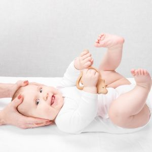 Happy baby receiving gentle chiropractic adjustments
