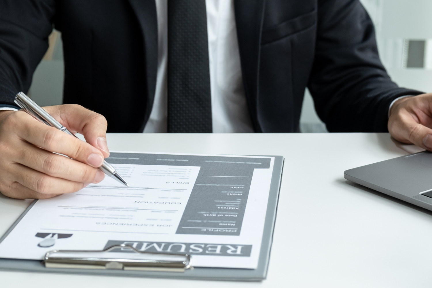 An employer reviewing an interviewee's resume.