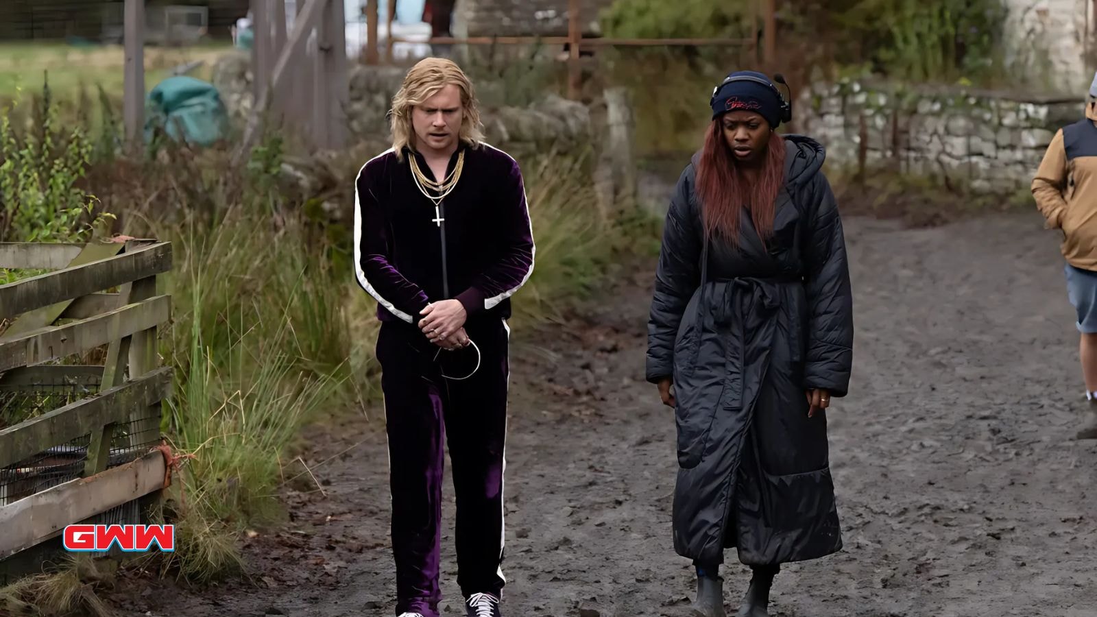 Jack O&rsquo;Connell walk side by side with another character on muddy path