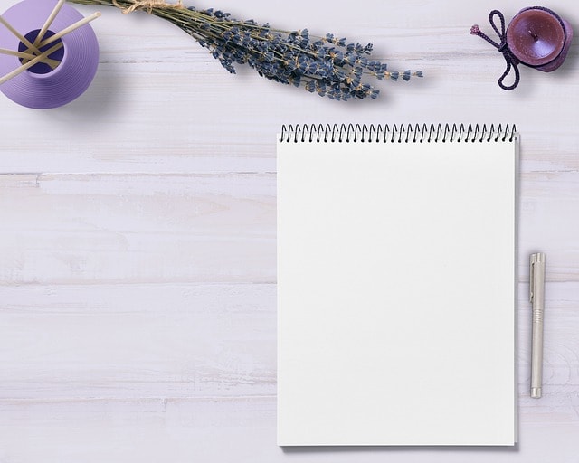 A table with a notebook and pen.