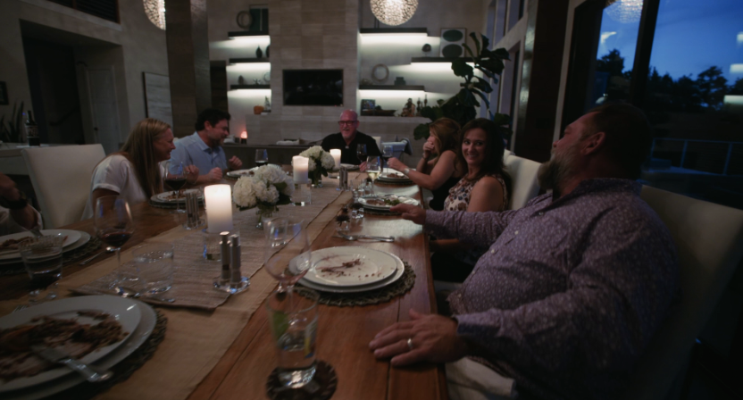 A dinner party with guests enjoying a meal prepared by a private chef
