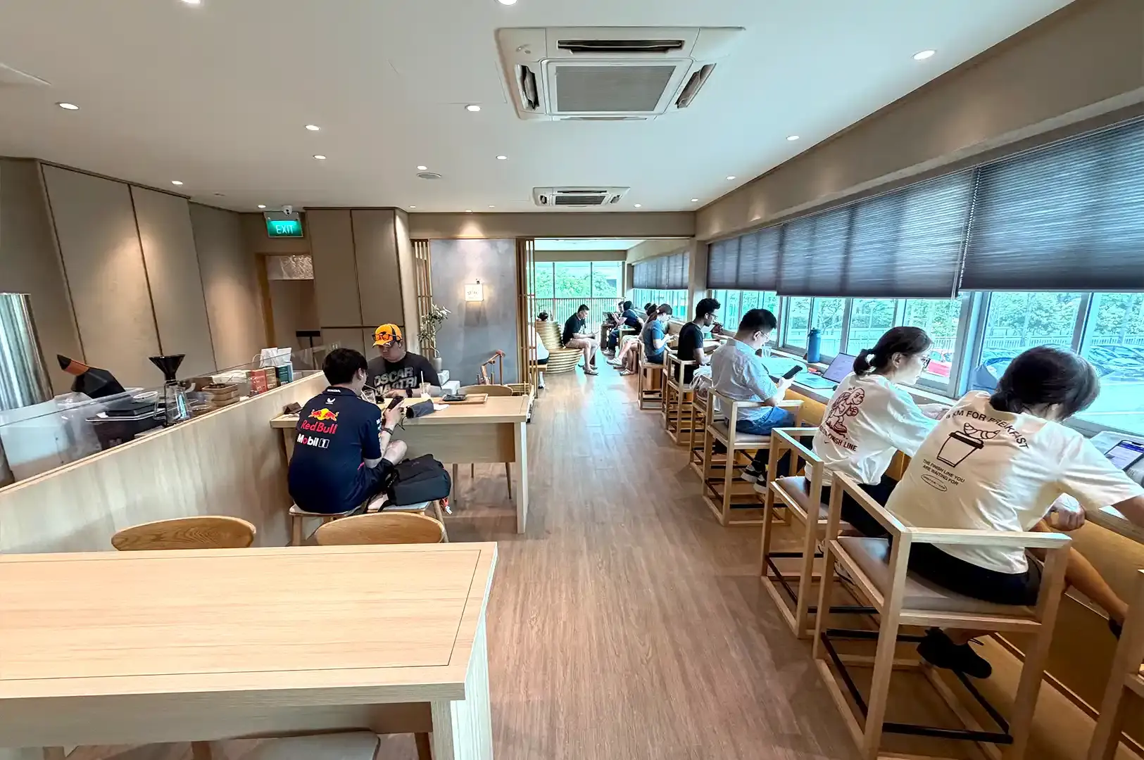 Suzuki Gourmet Coffee minimalist wooden interior and window counter seating offering specialty coffee and brunch in Singapore.