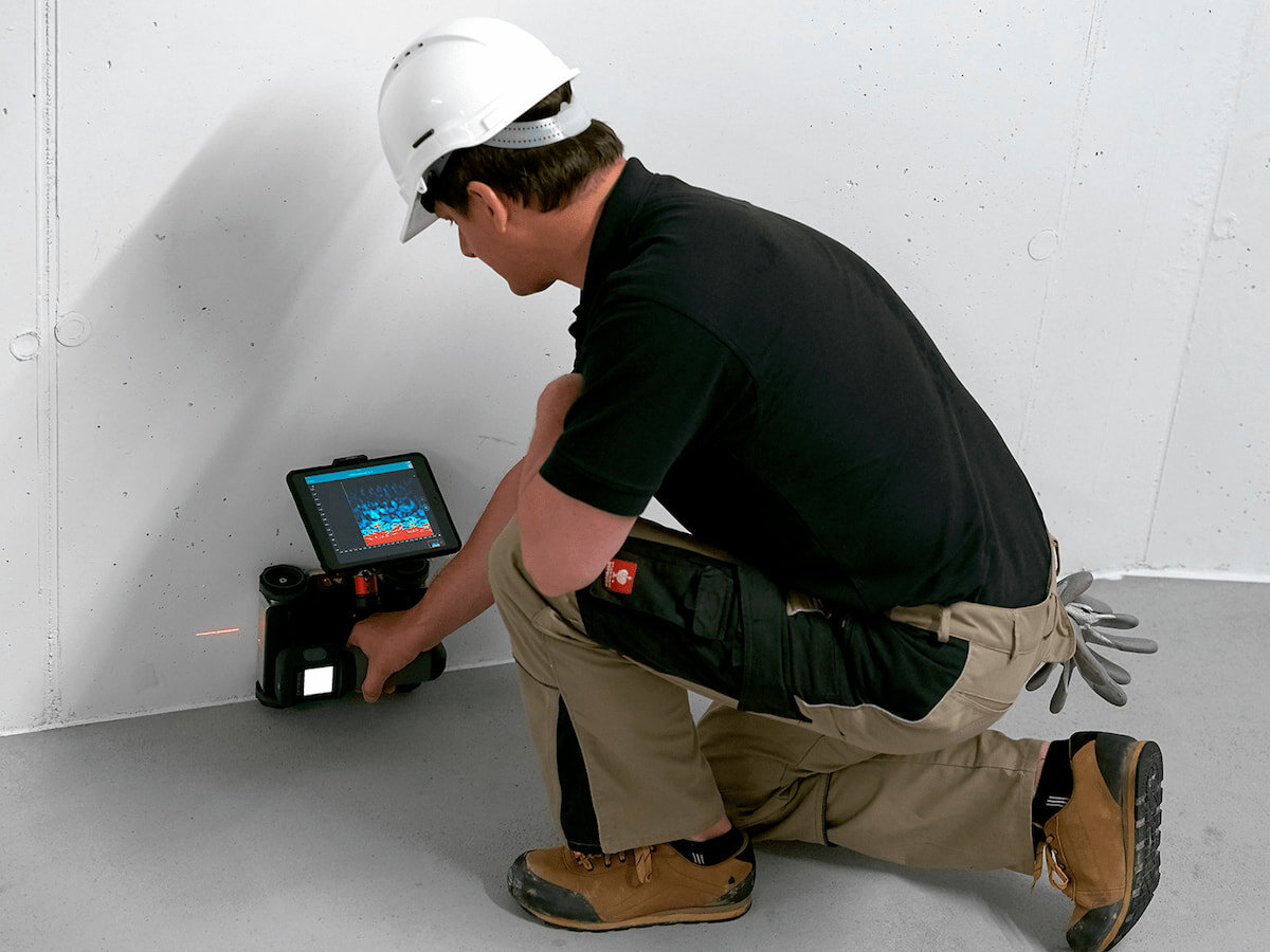 Ground penetrating radar (GPR) equipment being used to detect defects in concrete