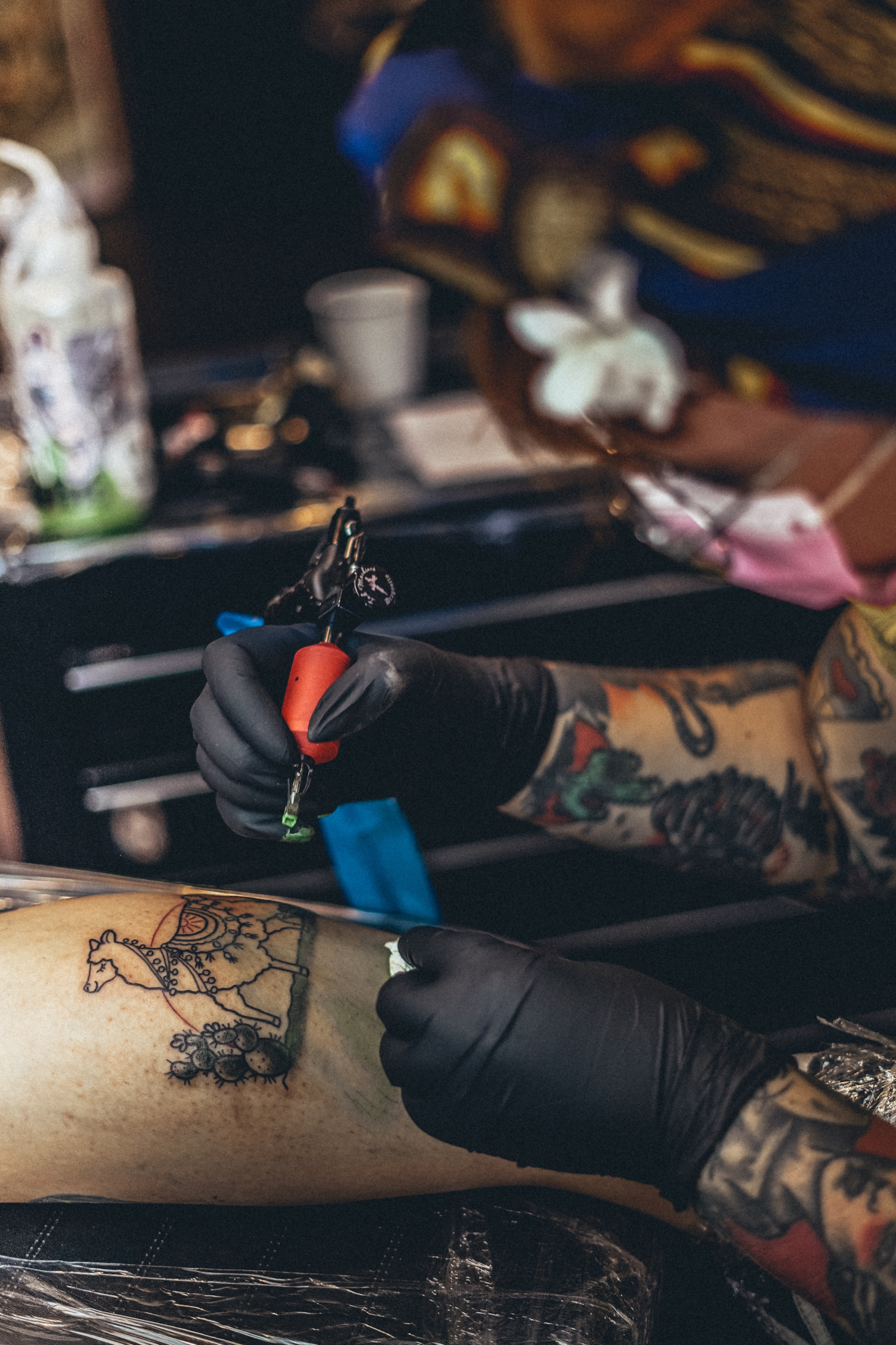 A Professional Tattoo Artist Making a Shin Tattoo