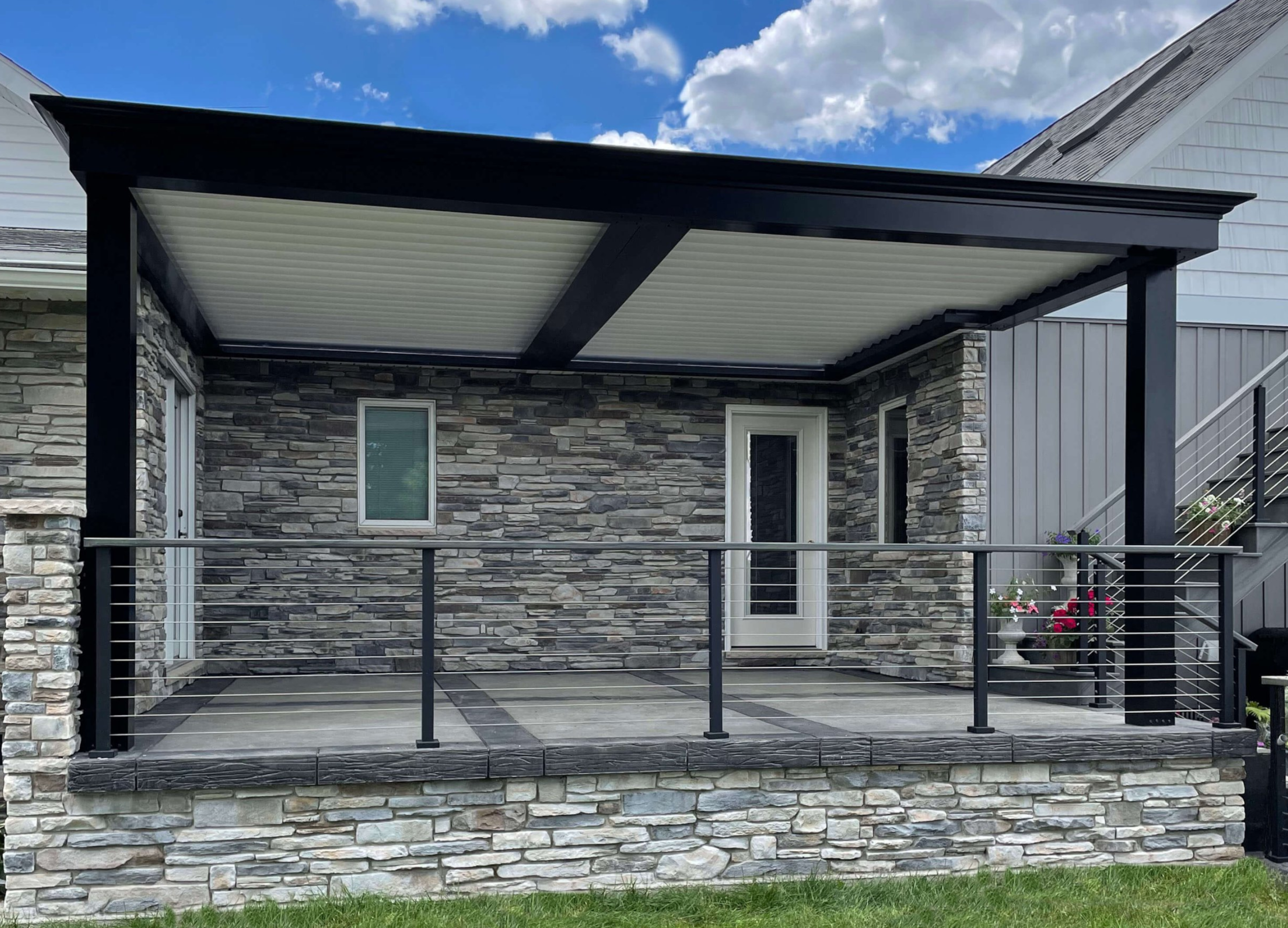 Black pergola with white louvers installed over