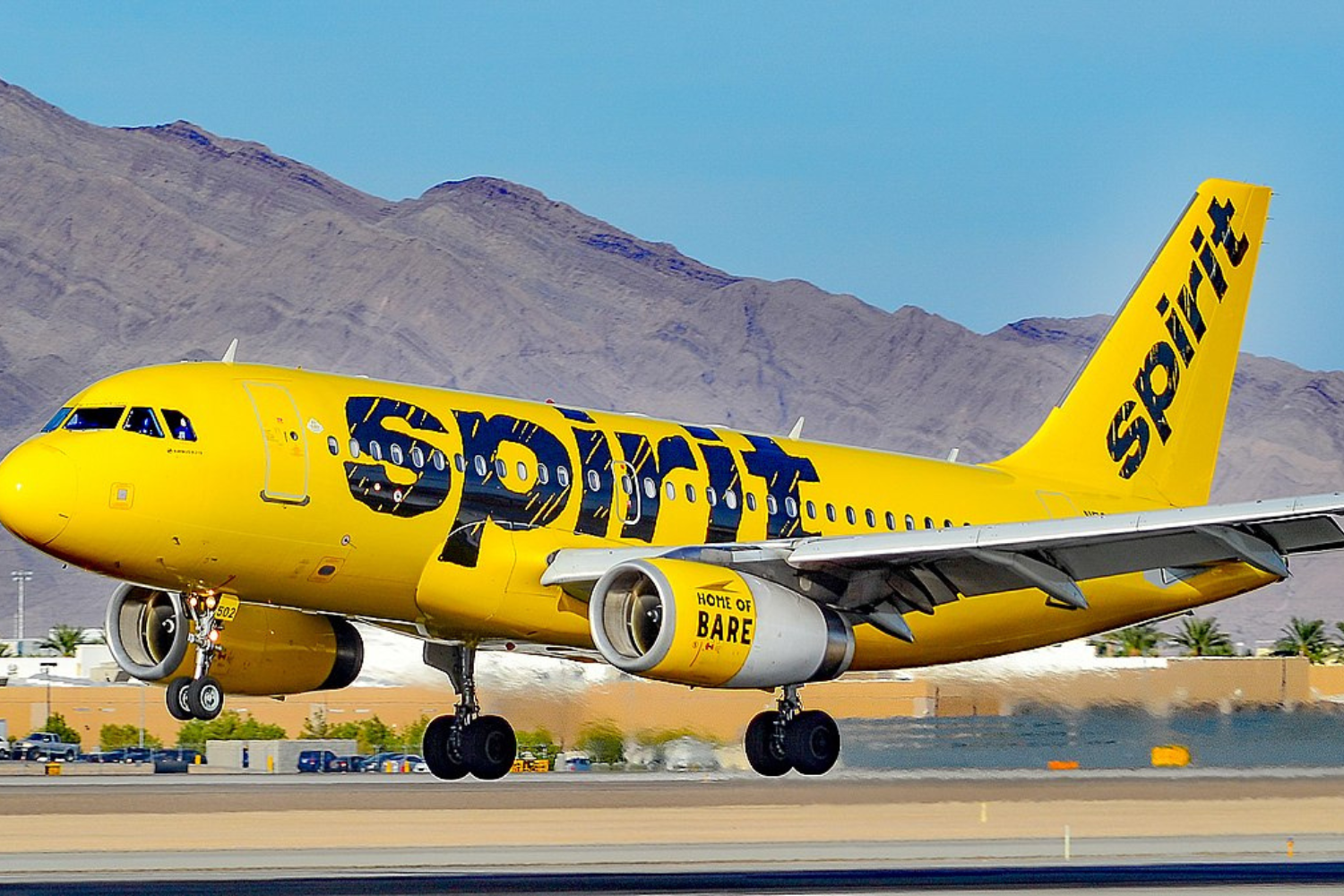a yellow spirit flight on the runway
