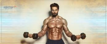 A man performing chest exercises at the gym, which may help in reducing gynecomastia or pseudogynecomastia, as per the query 'is it possible to get rid of gynecomastia with exercise'.