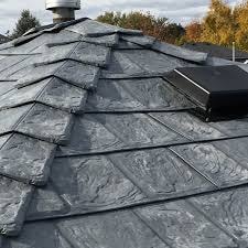 A close-up view of a grey metal roof, highlighting its smooth texture and contemporary appearance.