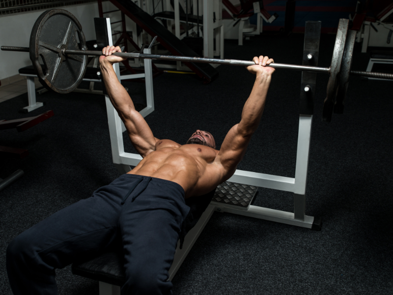 Strength training exercises during a flat bench workout.