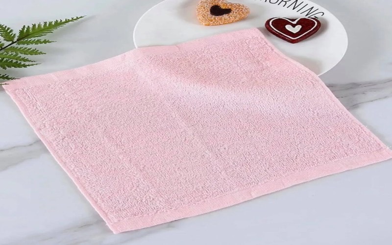 Pink square towel on a marble counter