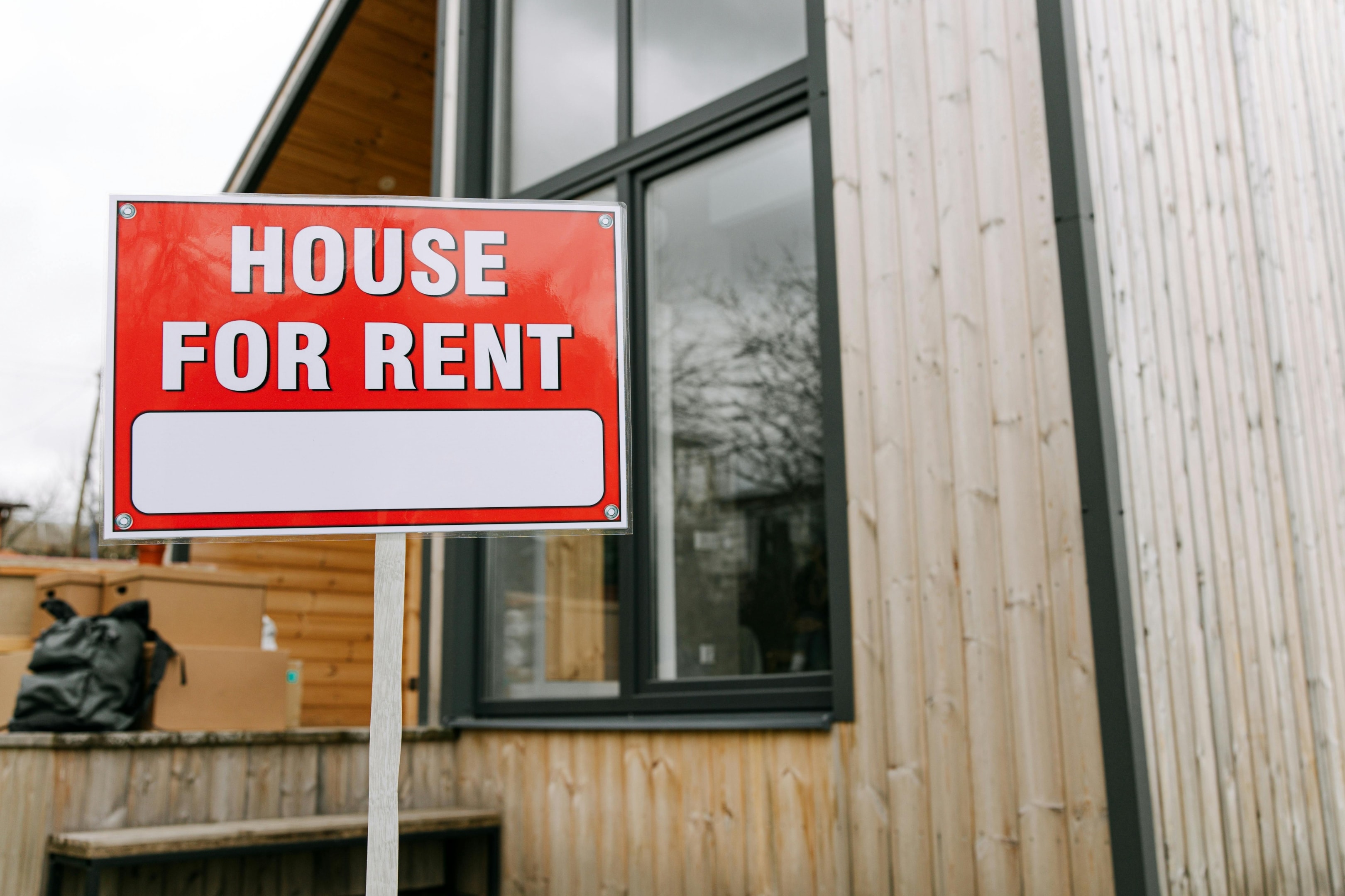 House for rent sign in front of house going through eviction of tenants.