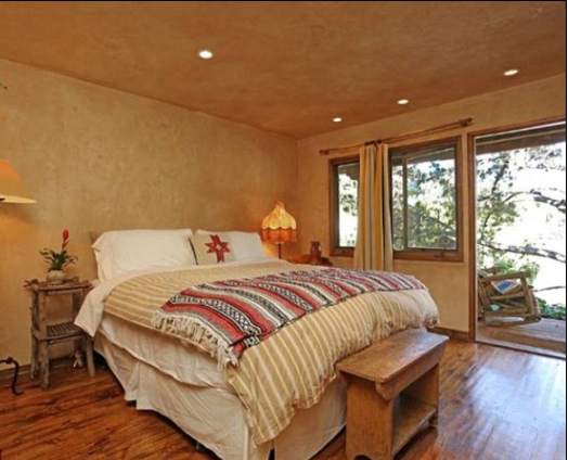 Tim Allen's fully furnished bedroom with a rustic design