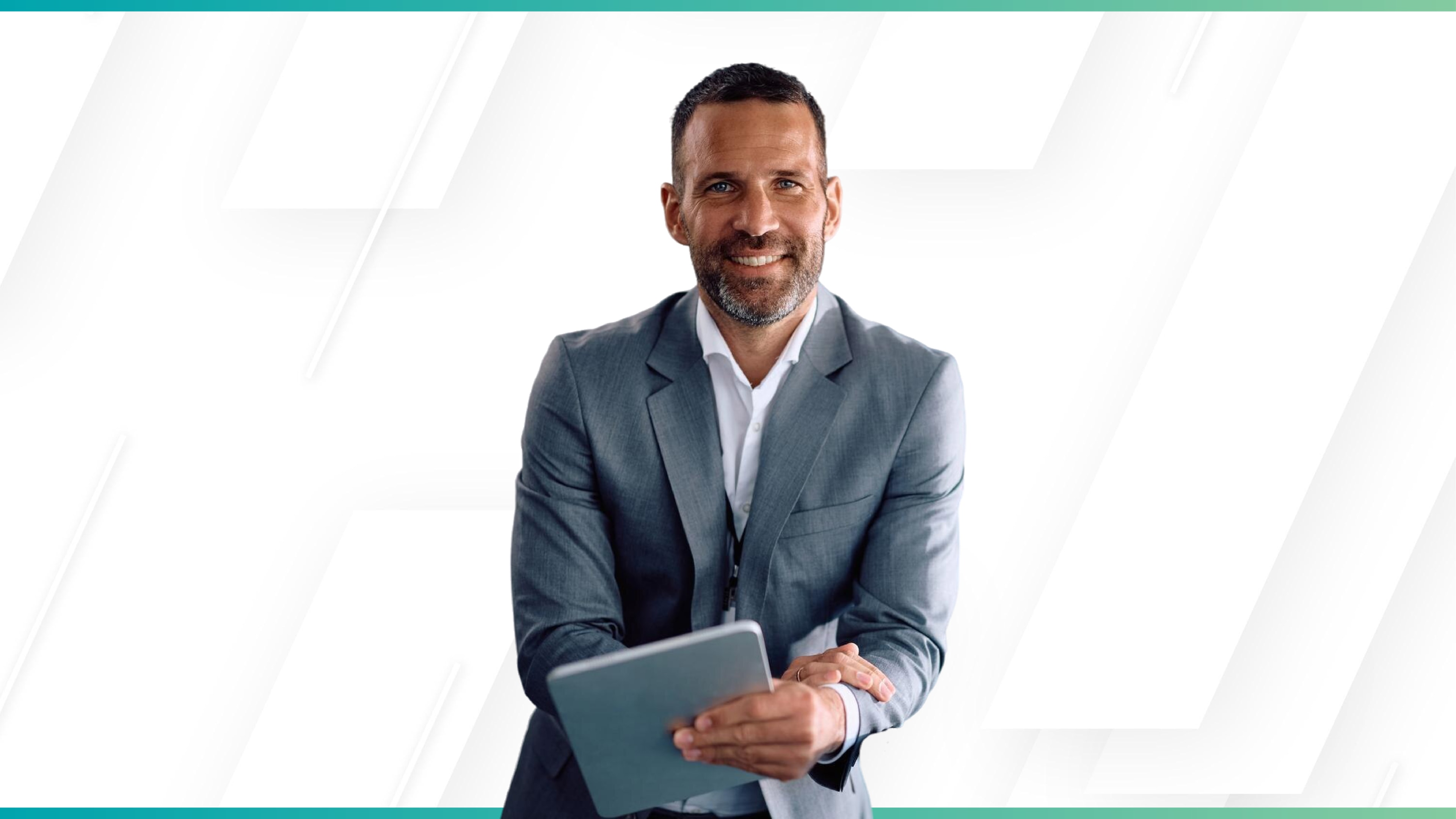 Businessman in a suit confidently holding a tablet and smiling against a clean, modern white background.